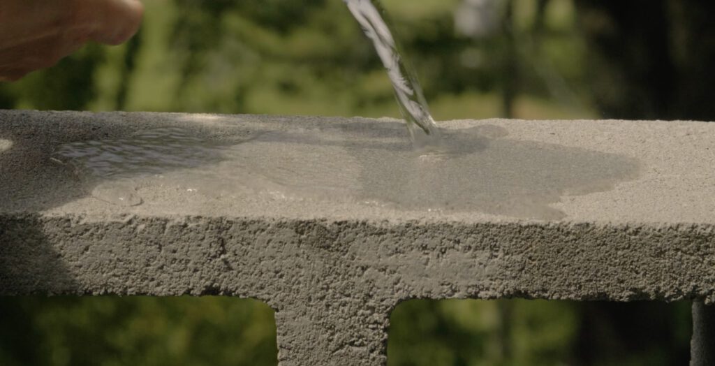 a water pouring into a concrete slab